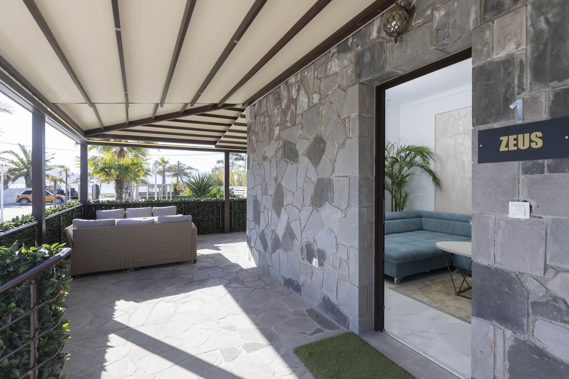 Entrance and covered terrace of a bungalow at Adonis Aegina Bungalows