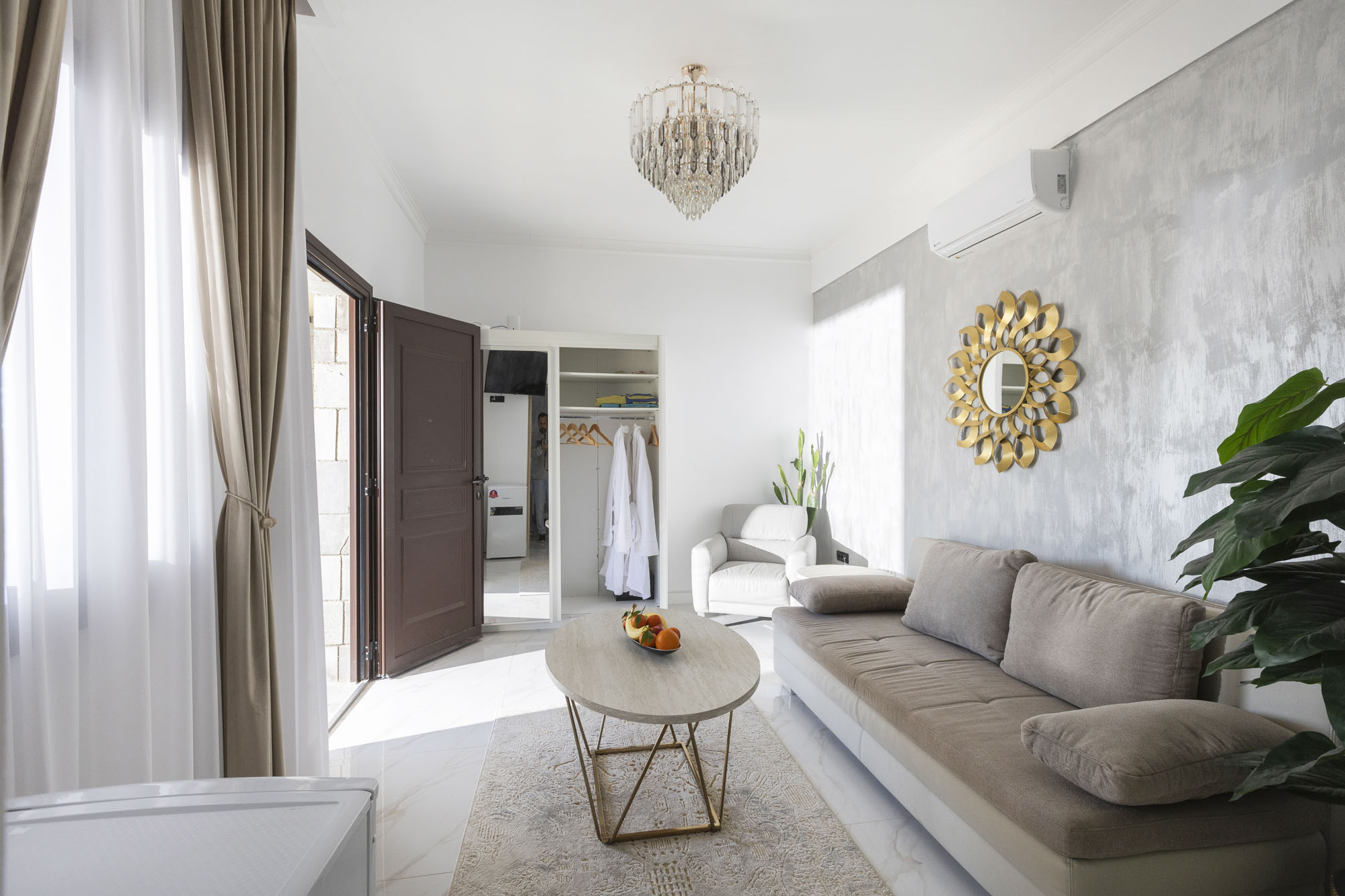 Living area with sofa and coffee table in Bungalow Apollo at Adonis Aegina Bungalows