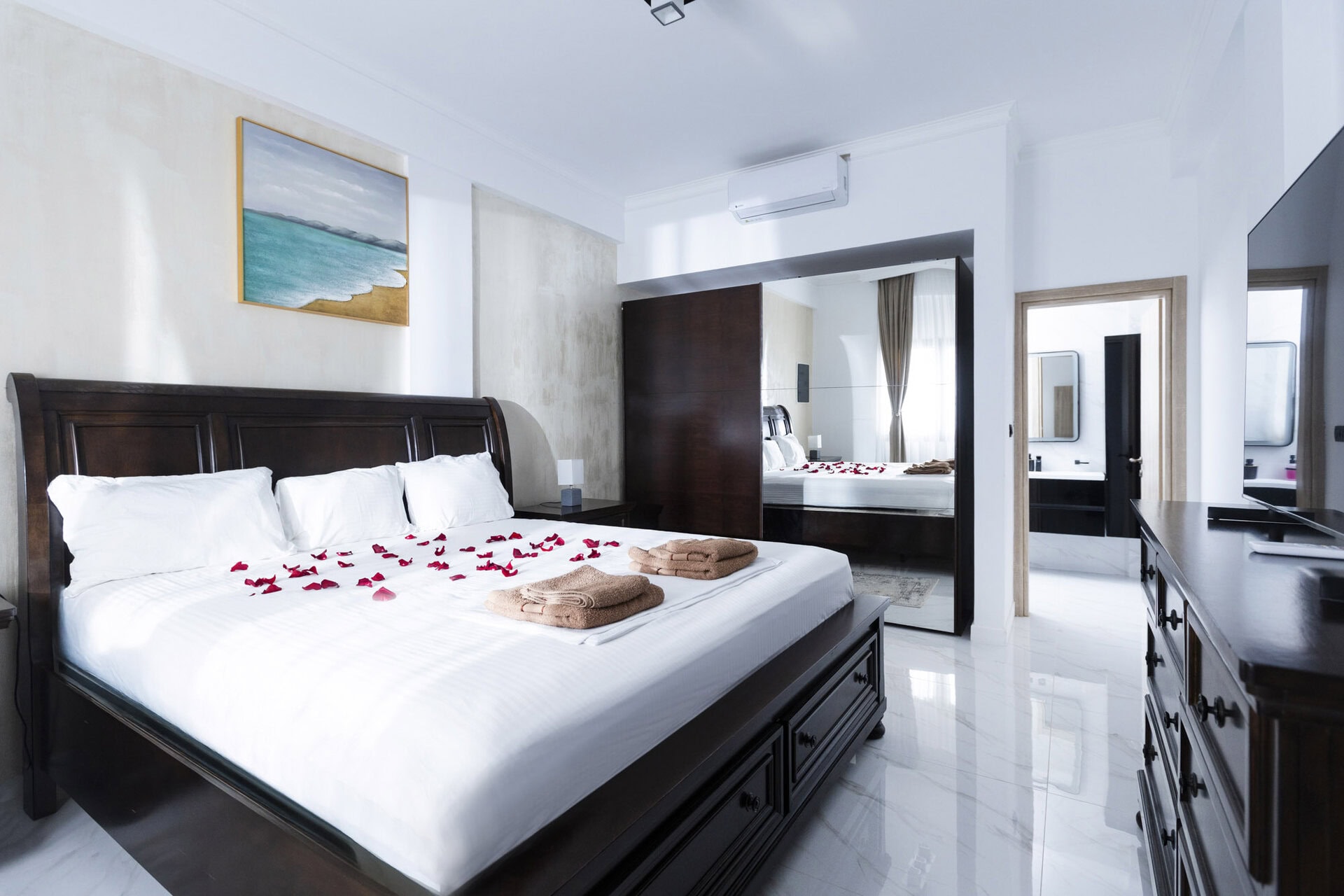 Bedroom interior with double bed and window in Bungalow Poseidon at Adonis Aegina Bungalows
