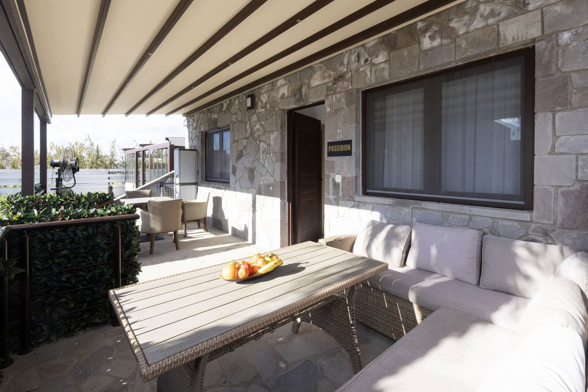 Private terrace with outdoor dining table at Bungalow Poseidon at Adonis Aegina Bungalows