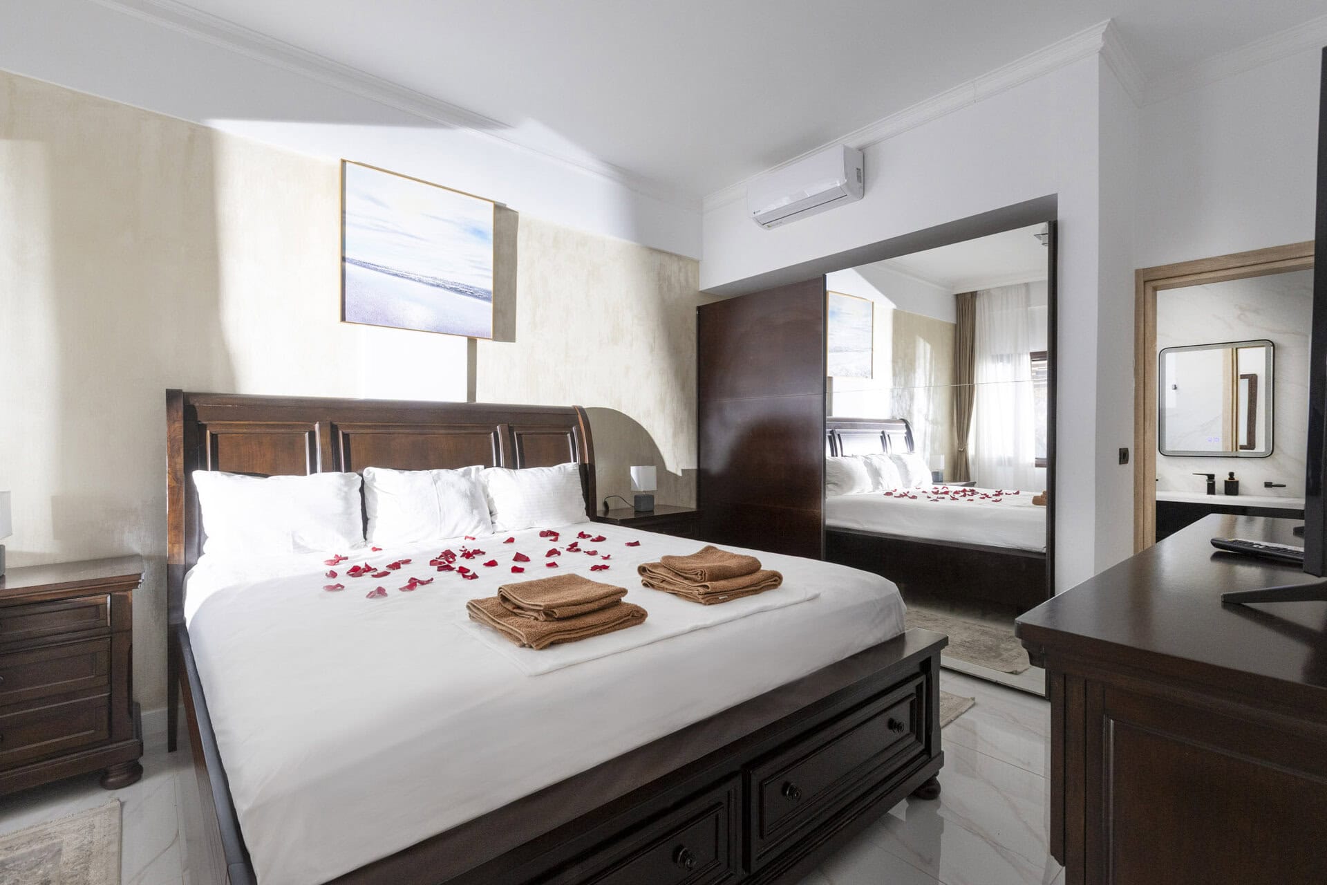 Bedroom with double bed and fresh linens in Bungalow Athena at Adonis Aegina Bungalows