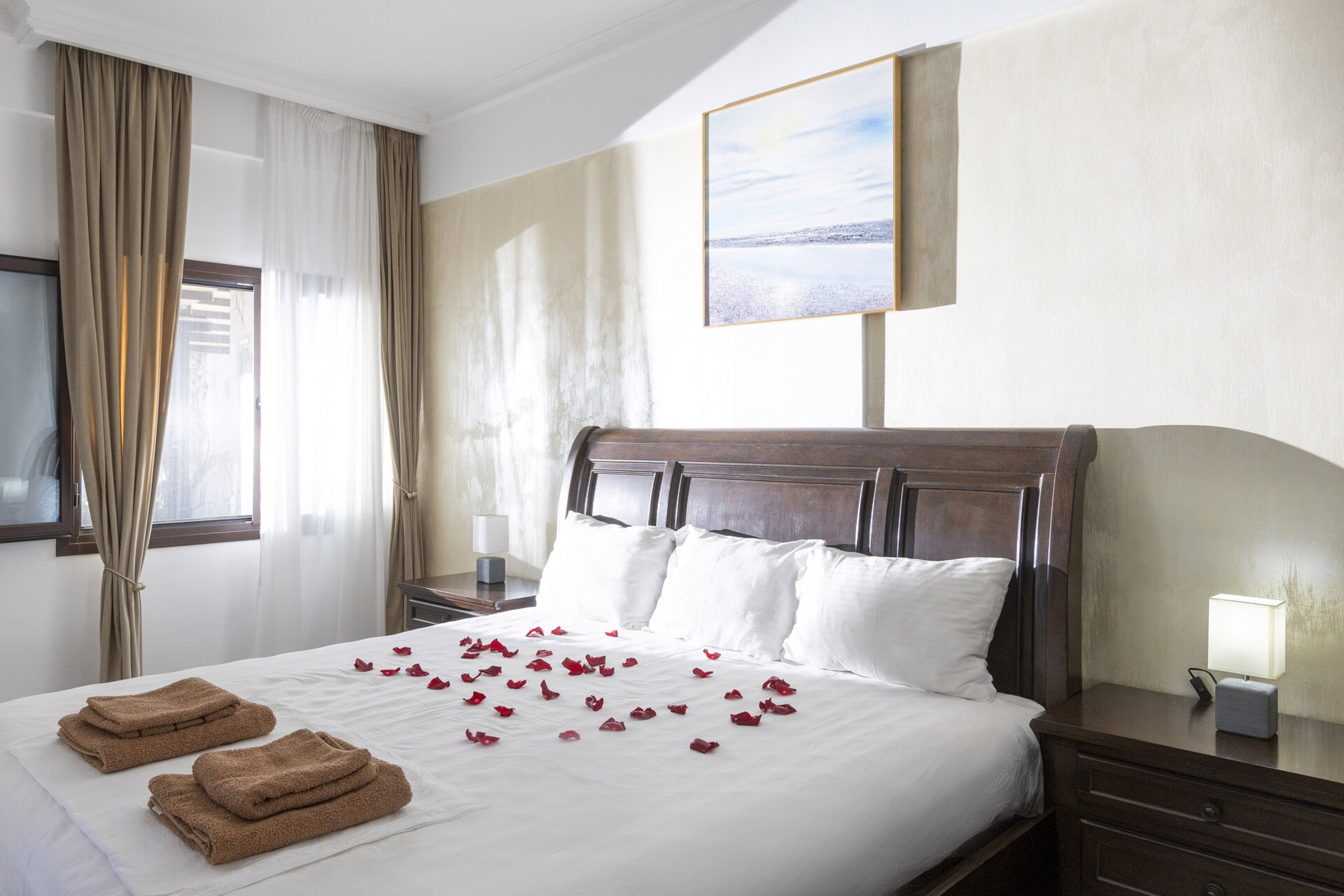 Bedroom interior with double bed and window in Bungalow Athena at Adonis Aegina Bungalows