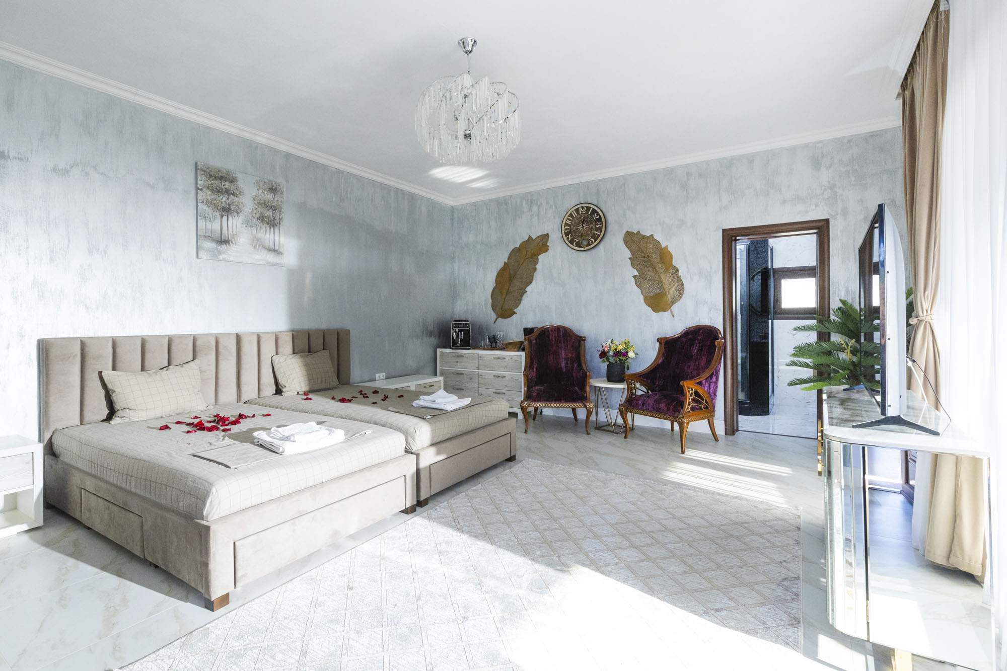 Spacious bedroom with double bed and seating area in Bungalow Hermes at Adonis Aegina Bungalows