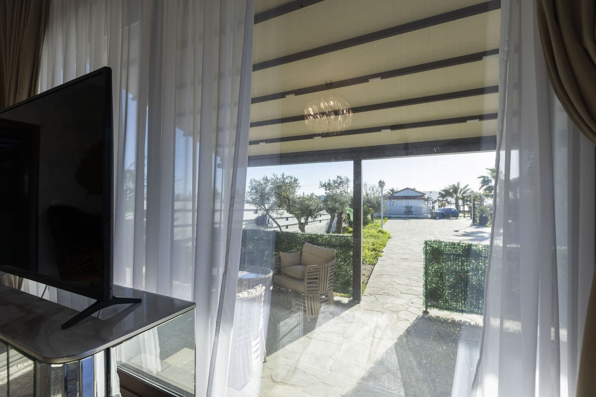 View from the terrace with outdoor seating at Bungalow Hermes at Adonis Aegina Bungalows