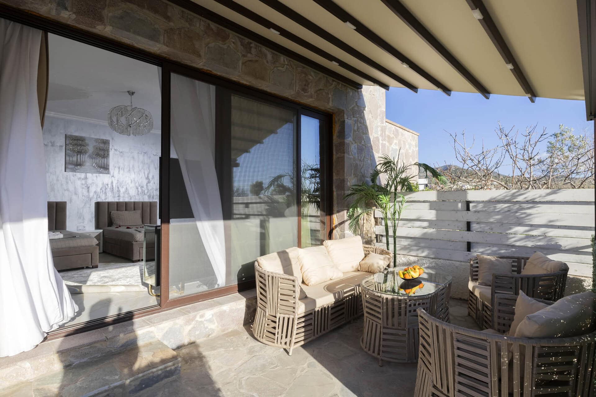 Covered outdoor seating area on the terrace of Bungalow Hermes at Adonis Aegina Bungalows