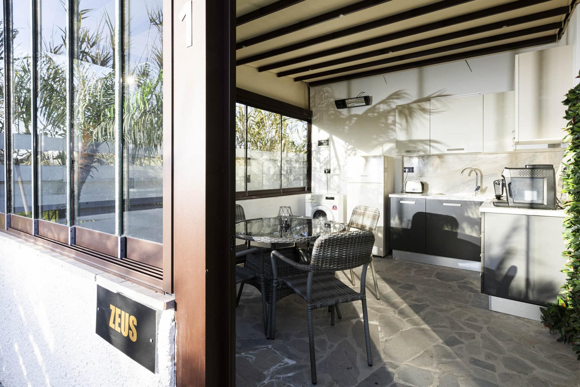 Private terrace seating area with garden views at Adonis Aegina Bungalows