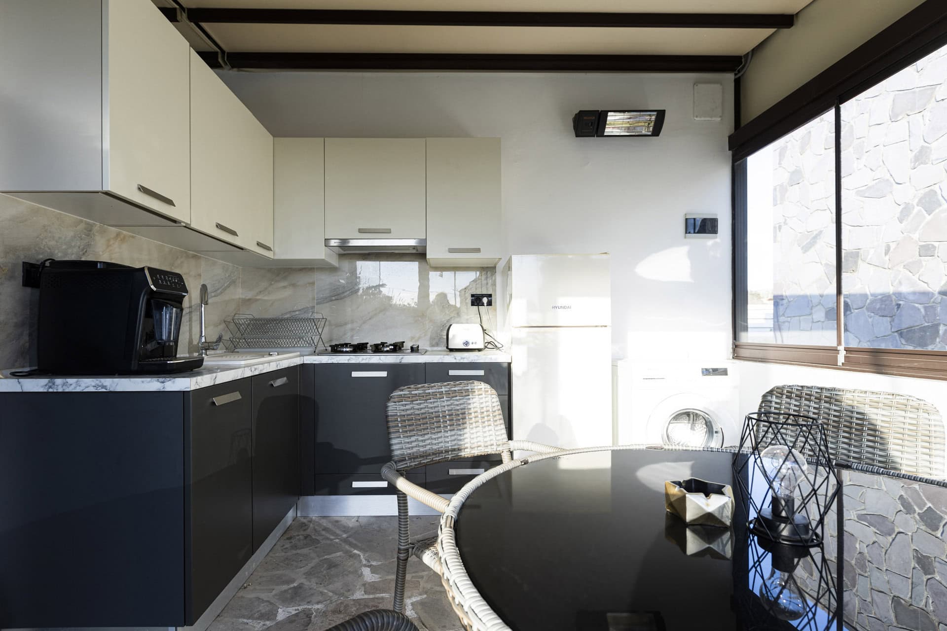 Kitchen and dining area in Bungalow Apollo at Adonis Aegina Bungalows